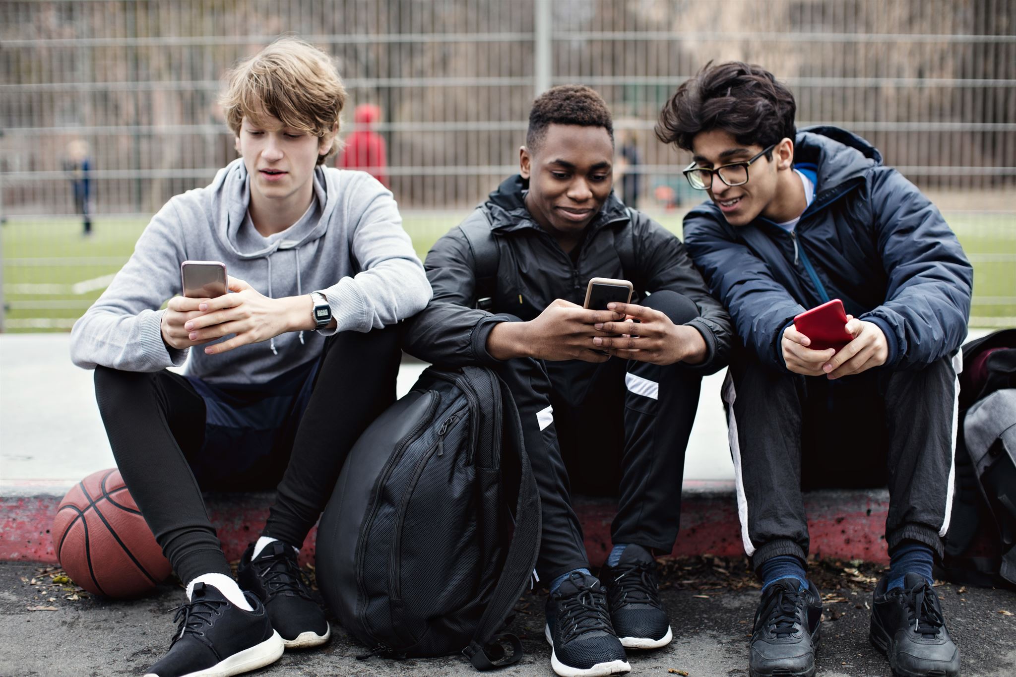 Boys-sitting-with-smartphones